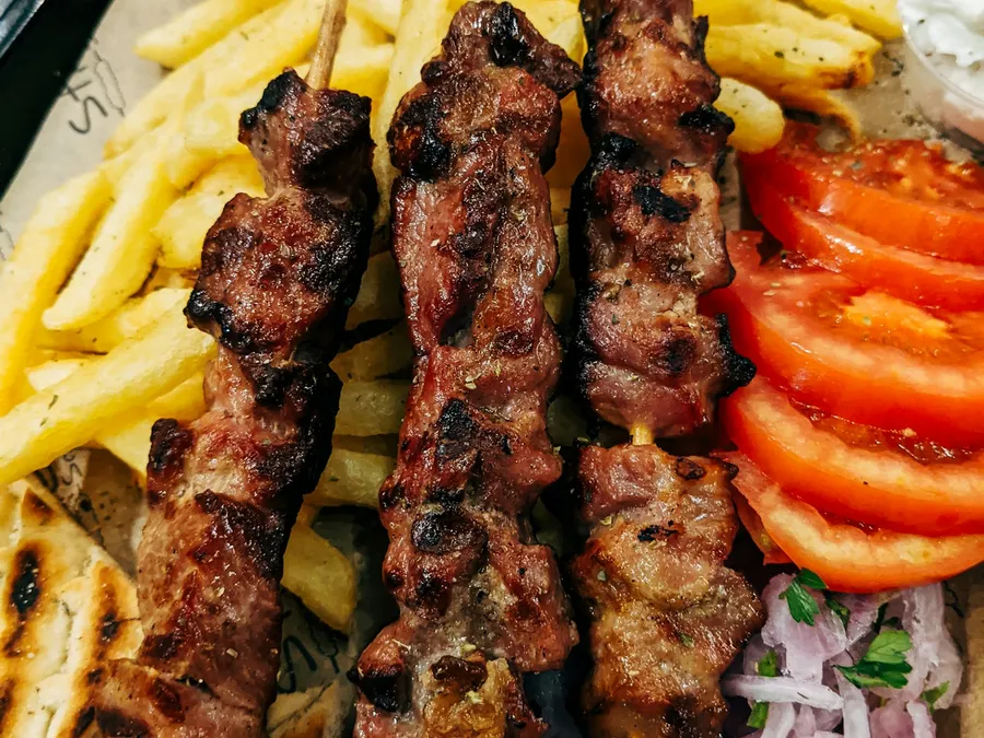 Kabob platter with fries and tomato